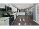 Modern kitchen featuring stainless steel appliances, granite counters, mosaic backsplash, and wood floors at 5142 Golfbrook Ct, Stone Mountain, GA 30088