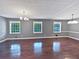 Bright living room featuring wood floors, recessed lighting, and three windows offering natural light at 5142 Golfbrook Ct, Stone Mountain, GA 30088