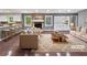 Beautifully staged living room with stone fireplace, modern furniture, and bright windows at 5142 Golfbrook Ct, Stone Mountain, GA 30088