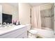 Bathroom with shower and tub combination, toilet, sink, and vanity with good lighting at 5633 Southland Dr, Stone Mountain, GA 30087