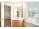 Bathroom with a vanity, mirror, and a window offering natural light at 5633 Southland Dr, Stone Mountain, GA 30087