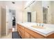 Well-lit bathroom featuring double sinks, tile floors, and white cabinets at 5633 Southland Dr, Stone Mountain, GA 30087