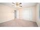 Bedroom with carpet, ceiling fan, a closet, and a window providing natural light at 5633 Southland Dr, Stone Mountain, GA 30087