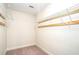 Walk-in closet featuring built-in shelving and rod for organized storage at 5633 Southland Dr, Stone Mountain, GA 30087