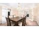 Formal dining room featuring classic molding, a modern table with seating for six, and double doors at 5633 Southland Dr, Stone Mountain, GA 30087
