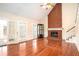 Bright living room with hardwood floors, brick fireplace, and access to sunroom at 5633 Southland Dr, Stone Mountain, GA 30087