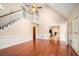 Bright, open living room boasts hardwood floors, a staircase, and connects seamlessly to the modern kitchen space at 5633 Southland Dr, Stone Mountain, GA 30087