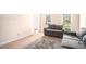 Cozy living room with a comfortable grey couch, area rug, and natural light from the large window at 5633 Southland Dr, Stone Mountain, GA 30087