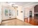 Sun-drenched sun room with tiled floor, leading into Gathering room with fireplace and gleaming hardwood floor at 5633 Southland Dr, Stone Mountain, GA 30087
