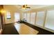 Bright sunroom with tile and carpet flooring, large windows, and a ceiling fan at 5633 Southland Dr, Stone Mountain, GA 30087