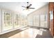 Enclosed sunroom with many windows allowing natural light, vaulted ceiling and tile floors at 5633 Southland Dr, Stone Mountain, GA 30087