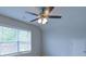 Bedroom features a ceiling fan, a window, and a door at 7570 Rambling Vale, Cumming, GA 30028