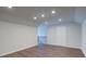 Bonus room with wood-look floors and recessed lighting featuring access to stairs at 7570 Rambling Vale, Cumming, GA 30028