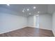 Bonus room with wood-look flooring, recessed lighting, and neutral paint, perfect for entertaining or relaxing at 7570 Rambling Vale, Cumming, GA 30028
