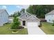 Charming one-story home with brick accents, well-manicured lawn, and a concrete driveway at 7570 Rambling Vale, Cumming, GA 30028