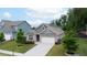 Charming one-story home with brick accents, well-manicured lawn, and a concrete driveway at 7570 Rambling Vale, Cumming, GA 30028