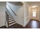 Hallway featuring wood floors, stairs, and paneled walls at 7570 Rambling Vale, Cumming, GA 30028