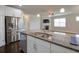 Kitchen island with stainless steel appliances, granite countertops, and plenty of storage at 7570 Rambling Vale, Cumming, GA 30028