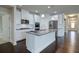Well-lit kitchen featuring stainless steel appliances, granite countertops, and white cabinets at 7570 Rambling Vale, Cumming, GA 30028