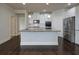 Kitchen with granite countertops, stainless steel appliances, and white cabinetry at 7570 Rambling Vale, Cumming, GA 30028