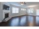 Spacious living room featuring a fireplace and wood floors at 7570 Rambling Vale, Cumming, GA 30028
