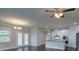 Spacious open-concept living area featuring hardwood floors, modern lighting fixtures, and a view of the kitchen at 7570 Rambling Vale, Cumming, GA 30028