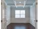 Office space with a decorative ceiling, wainscotting, wood floors, and a window at 7570 Rambling Vale, Cumming, GA 30028