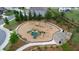 Aerial view of the community playground with mature trees, various play structures and covered seating at 7570 Rambling Vale, Cumming, GA 30028