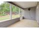 Enclosed patio area with fan and view of backyard at 7570 Rambling Vale, Cumming, GA 30028