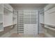 Spacious walk-in closet with custom shelving, drawers, and ample storage space for clothes and accessories at 7570 Rambling Vale, Cumming, GA 30028