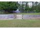 Backyard with a retaining wall, stairs, a fence, and trees at 2101 Emerald Dr, Loganville, GA 30052