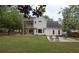 Backyard featuring a patio, deck, and lush green lawn with trees and foliage at 2101 Emerald Dr, Loganville, GA 30052