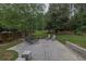 Spacious backyard with a patio, outdoor furniture, and lush green lawn and trees at 2101 Emerald Dr, Loganville, GA 30052