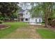 Expansive backyard featuring a spacious lawn and a charming patio with outdoor seating at 2101 Emerald Dr, Loganville, GA 30052