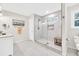 Modern bathroom with a glass-enclosed shower, white marble floors, and updated fixtures at 2101 Emerald Dr, Loganville, GA 30052