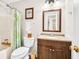 Bathroom with a vanity, mirror, toilet, and shower with a decorative shower curtain at 2101 Emerald Dr, Loganville, GA 30052