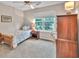 Cozy bedroom with a single bed, a nightstand, and a window offering a view at 2101 Emerald Dr, Loganville, GA 30052