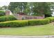Elegant brick entrance to Emerald Cove with lush greenery, creating a welcoming atmosphere at 2101 Emerald Dr, Loganville, GA 30052