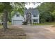 Charming two-story home features a two-car garage, well-manicured lawn, and a classic white and brick facade at 2101 Emerald Dr, Loganville, GA 30052