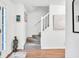 Bright hallway featuring hardwood floors, white trim, and stairway to the upper level at 2101 Emerald Dr, Loganville, GA 30052
