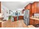 Spacious kitchen features stainless steel appliances, wood cabinets, and an island with stylish light fixtures at 2101 Emerald Dr, Loganville, GA 30052