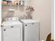 Functional laundry room equipped with modern washer and dryer for efficient chores at 2101 Emerald Dr, Loganville, GA 30052