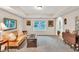 Another angle of the living room featuring neutral carpet, tray ceilings, large windows, and an archway at 2101 Emerald Dr, Loganville, GA 30052