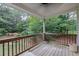 Outdoor porch with wooden floors and a view of the tranquil, wooded surroundings at 2101 Emerald Dr, Loganville, GA 30052