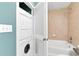 Full bathroom with stackable washer and dryer and tiled tub surround at 3300 Windy Ridge Se Pkwy # 1107, Atlanta, GA 30339