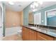 Updated bathroom featuring granite countertop and tub with beige tile surround at 3300 Windy Ridge Se Pkwy # 1107, Atlanta, GA 30339