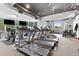 Well-equipped gym with treadmills, weights, and large windows overlooking the neighborhood at 3300 Windy Ridge Se Pkwy # 1107, Atlanta, GA 30339