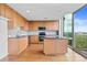 Modern kitchen featuring wood cabinets, granite countertops, stainless steel appliances, and an island with a view at 3300 Windy Ridge Se Pkwy # 1107, Atlanta, GA 30339