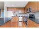 Modern kitchen featuring wood cabinets, granite countertops, stainless steel appliances, and an island at 3300 Windy Ridge Se Pkwy # 1107, Atlanta, GA 30339