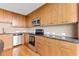 Kitchen featuring wood cabinets, granite countertops, and stainless steel appliances at 3300 Windy Ridge Se Pkwy # 1107, Atlanta, GA 30339